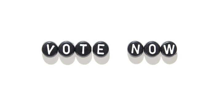 Vote now message in black and white beads on white background for election awareness. photo