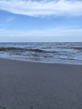 A person is flying a kite on a beach photo