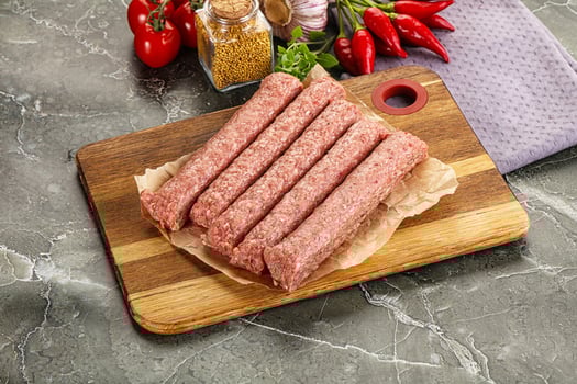 Raw beef kebab sausage for grill photo