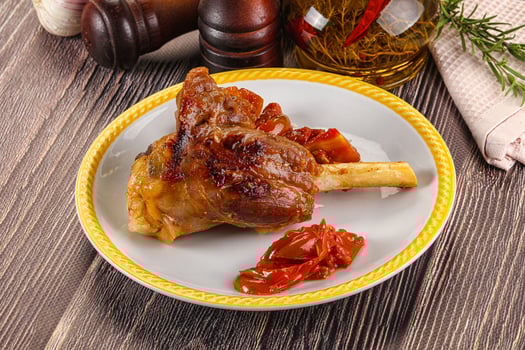 Baked lamb shank with vegetables photo