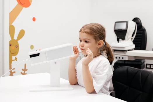 A young girl engages in orthoptic and pleoptic therapy using advanced vision stimulation equipment. Laser eye treatment promotes recovery and enhances vision in a soothing environment photo