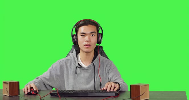POV of man enjoying games at pc while he talks to his friends on headphones, playing computer action game at his workstation desk. Young gamer having fun with gameplay. photo