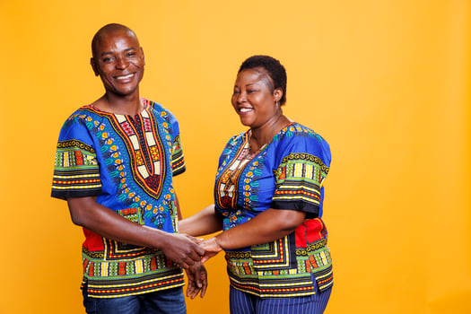 Smiling happy mid adult couple holding hands and posing together for family portrait. Man and woman spouse with cheerful expression showing affection and looking at camera photo