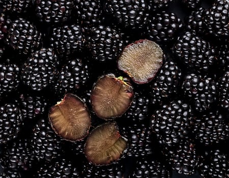 Overhead view of Fresh, Pile, Ripe and juicy sweet Blackberry fruits. Halves food summer background photo
