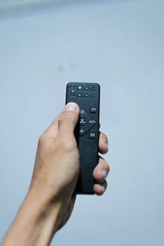 A hand holding a remote photo