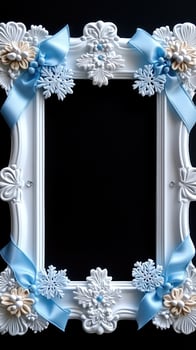 White ornate picture frame decorated with blue ribbons and snowflakes for christmas photo