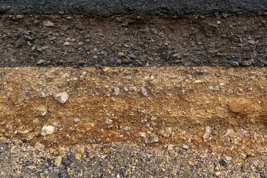 The layer of asphalt road with soil and rock. photo
