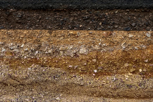 The layer of asphalt road with soil and rock. photo