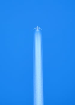 Airplane Flying High in Clear Blue Sky with Contrail - Minimalist Aerial Photography photo