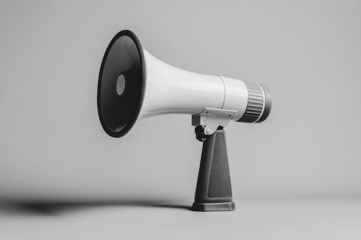 White Megaphone with Black Handle and Speaker on Gray Background photo