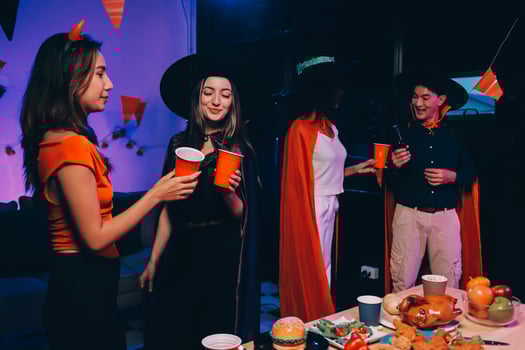 Joyful office Halloween party with coworkers in costumes, celebrating with drinks and laughter, fostering teamwork and festive spirit photo