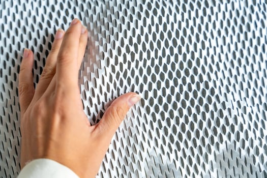 Hand on texture of corrugated white paper for safe transportation, in which the goods brought by the courier delivery service are wrapped, environmental packaging concept. High quality photo
