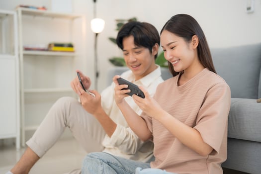 Young couple enjoying smartphone entertainment at home photo