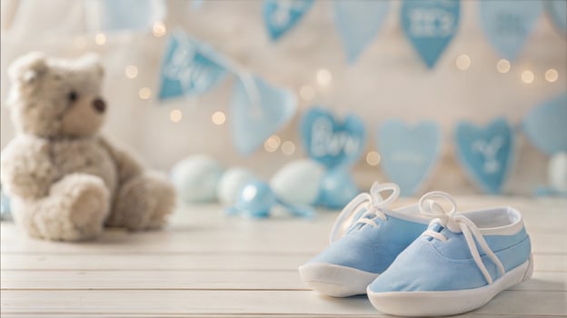 Blue baby shoes and teddy bear on wooden floor photo