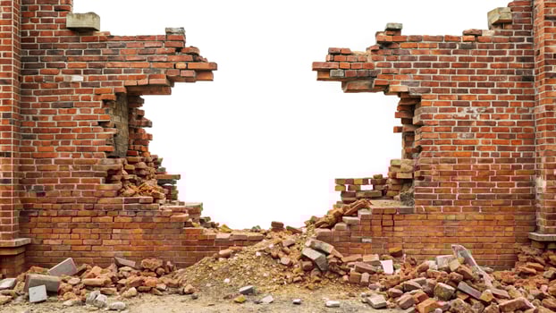 Panoramic view of a demolished brick building wall with rubble pile isolated on white background photo