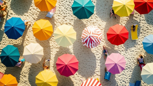 Colorful beach umbrellas provide shade for sunbathers enjoying a sunny day at the seaside during summer, creating a vibrant atmosphere photo