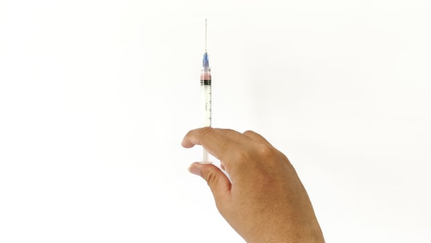 Vial of Drug or Vaccine and 3 ml Plastic Syringe with Needle Isolated on the White Background, blue tone color photo