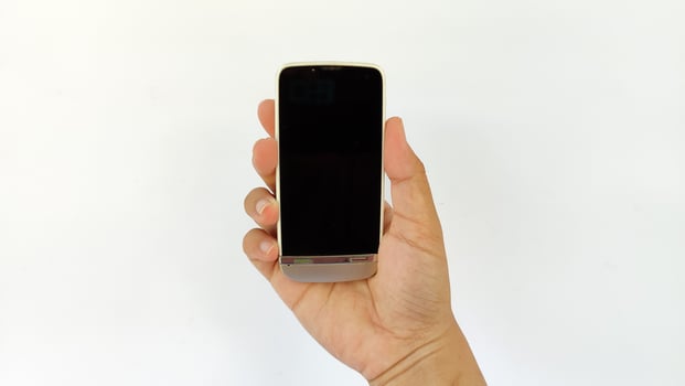 Closeup shot of hand holding handphone photo