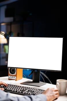 African american man staring at white screen on computer, working from home with blank empty copyspace display. Male web programmer looks at isolated chromakey layout on pc screen. photo