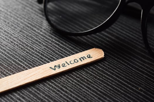 stick of ice cream with the words welcome and the eyeglasses. Motivational quotes, optimism, positive words on the table photo