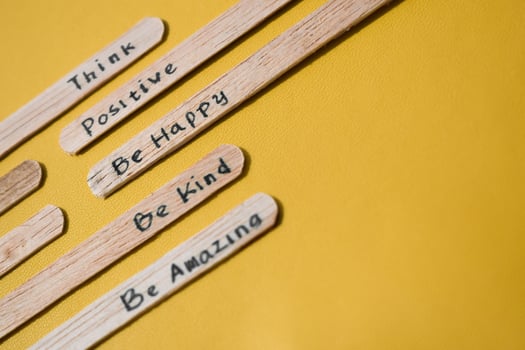 stick of ice cream with the words Think Positive, Be happy, Be Kind, Be Amazing. Motivational quotes, optimism, positive words. Isolated on background photo