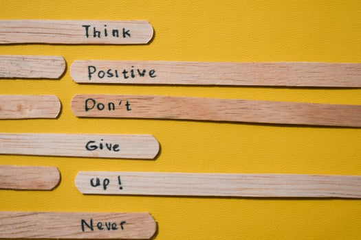 stick of ice cream with the words Think Positive, Dont give up, Never quit. Motivational quotes, optimism, positive words. photo