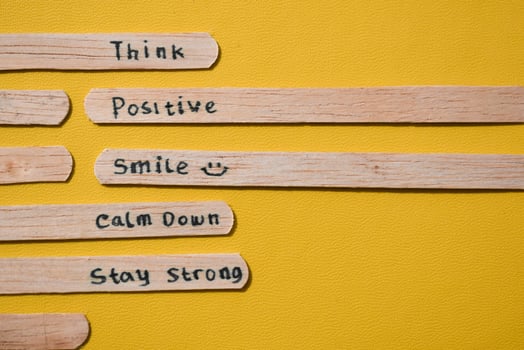 stick of ice cream with the words Think Positive, Smile, calm dowm, Stay strong. Motivational quotes, optimism, positive words. Isolated on background photo