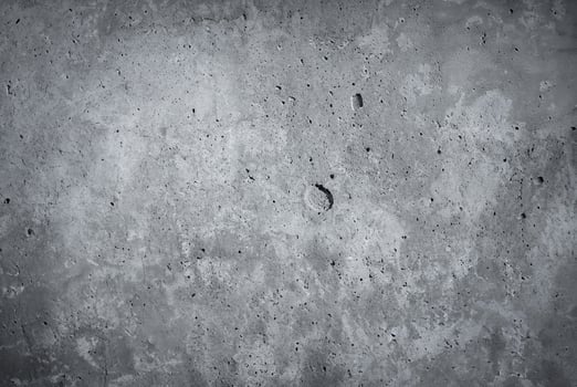 Close-up of a rough gray concrete wall texture, ideal for backgrounds or construction-related projects photo