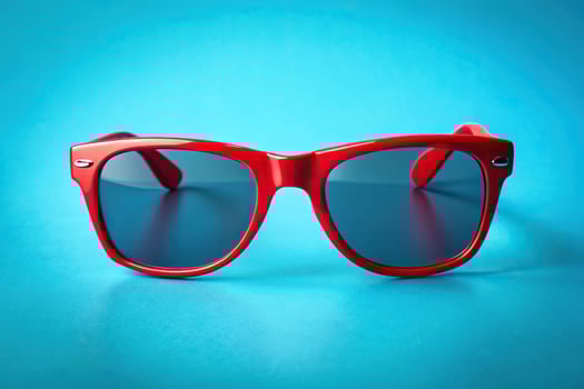 red retro style sunglasses on blue background photo