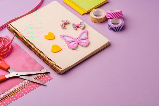 Crafting supplies on a purple background ready for creative projects photo
