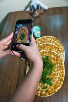 Taking a Photo of Turkish Pide on a Wooden Table