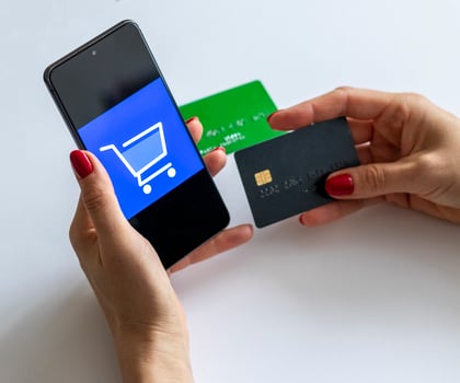 Shot of the woman holding credit card and the phone. Technology photo