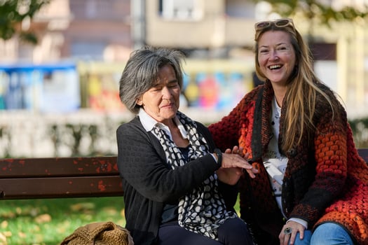 Embracing Generations. A Daughter's Love and Support for Her Senior Mother on a Sunny Day in the Park photo