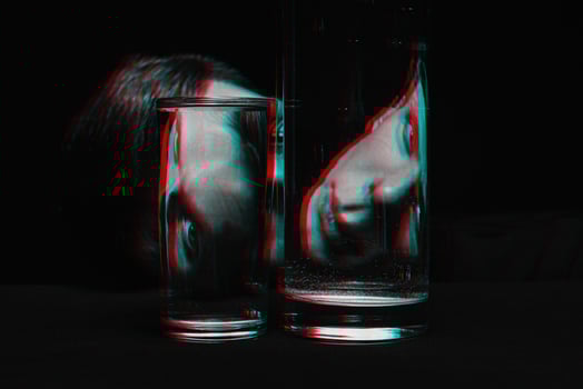 portrait of a man looking through two glasses of water photo