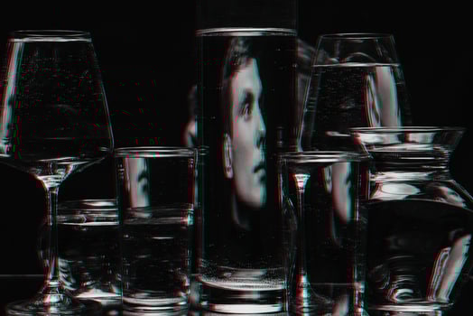 strange abstract portrait of a man through the glass of the tank with water with the reflections and distortions photo