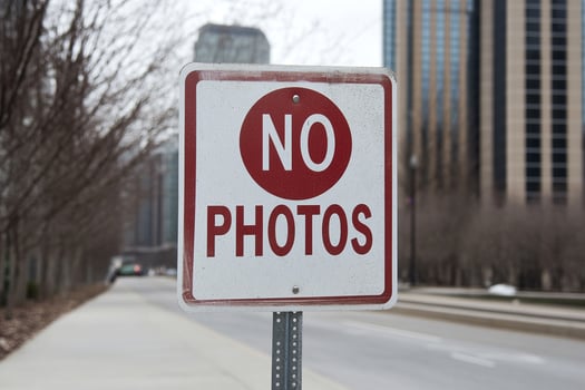 A no photos sign on a street