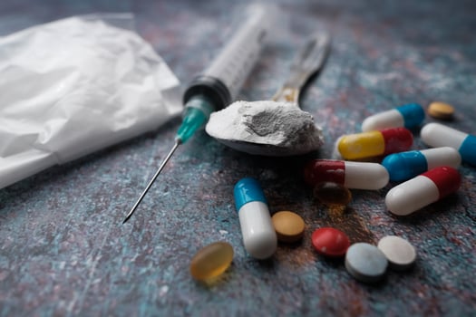 An assortment of various drugs and medical supplies displayed on a table surface photo