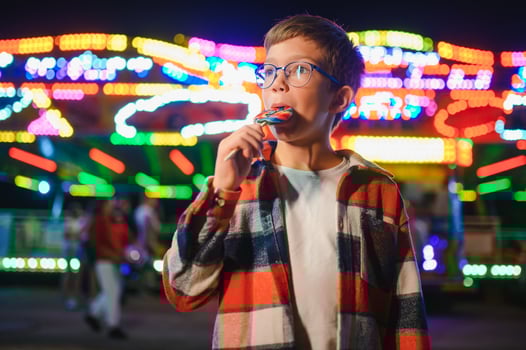 Happy boy in amusement park. Happy childhood concept photo