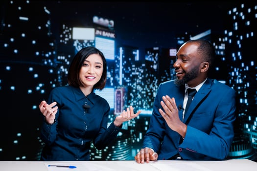 Journalists team on late night show discussing about latest information from media newspapers, global communications. Diverse presenters working on television content, broadcasting live. photo