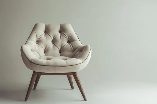 Chic modern chair with button tufts and angular wooden legs isolated photo