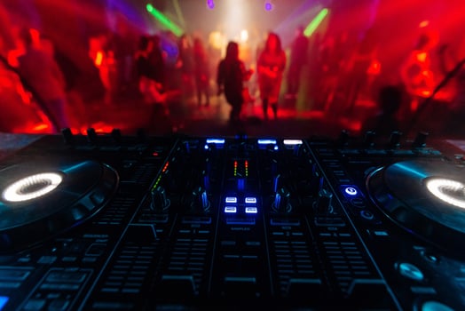 professional DJ mixer controller for mixing music in a nightclub photo