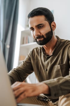 Serious indian man, freelancer working on laptop at home office, handsome middle aged photo