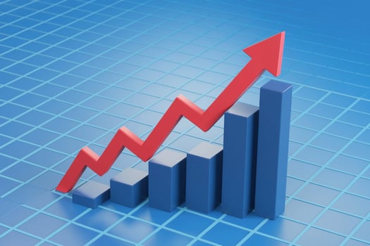 Red line rising sharply on a blue grid, indicating growth photo