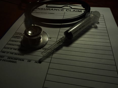 Stethoscope and syringe put together photo