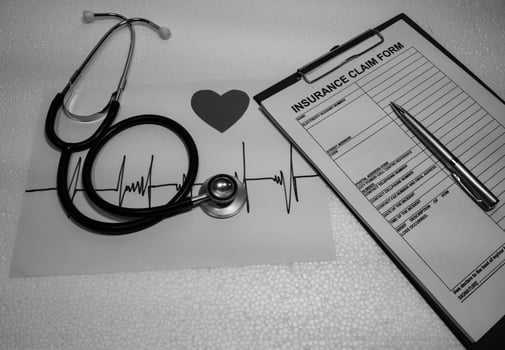 Stethoscpoe put beside insurance form. photo