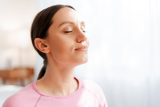 Beautiful women with closed eyes breathing while relaxing after exercising workout photo