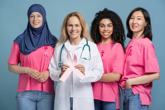 Doctor, diverse multinational patients smiling and showing pink ribbon for breast cancer awareness photo