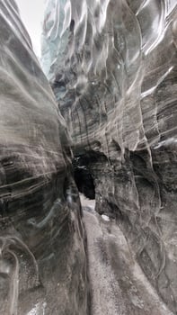 Ice tunnels with visibly shattered glacier rocks at Vatnajokull iceberg. Ice caves pathways with icy chunks used for glacier hiking next to gorgeous cracked blocks of ice. photo