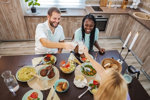 Friends gather to celebrate with a joyful meal at home photo
