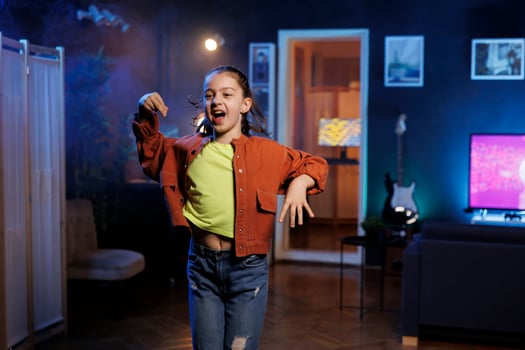 Popular child takes part in viral dance trend after seeing favorite celebrities doing it, filming family channel for children audience. Generation Z online star does trendy dancing challenge photo